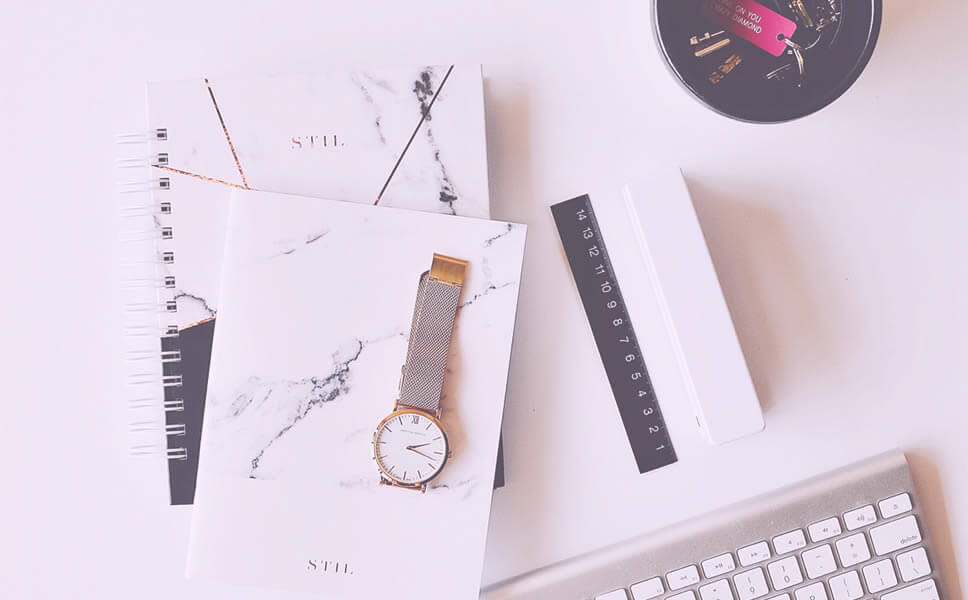 planners, watch and keys on the table
