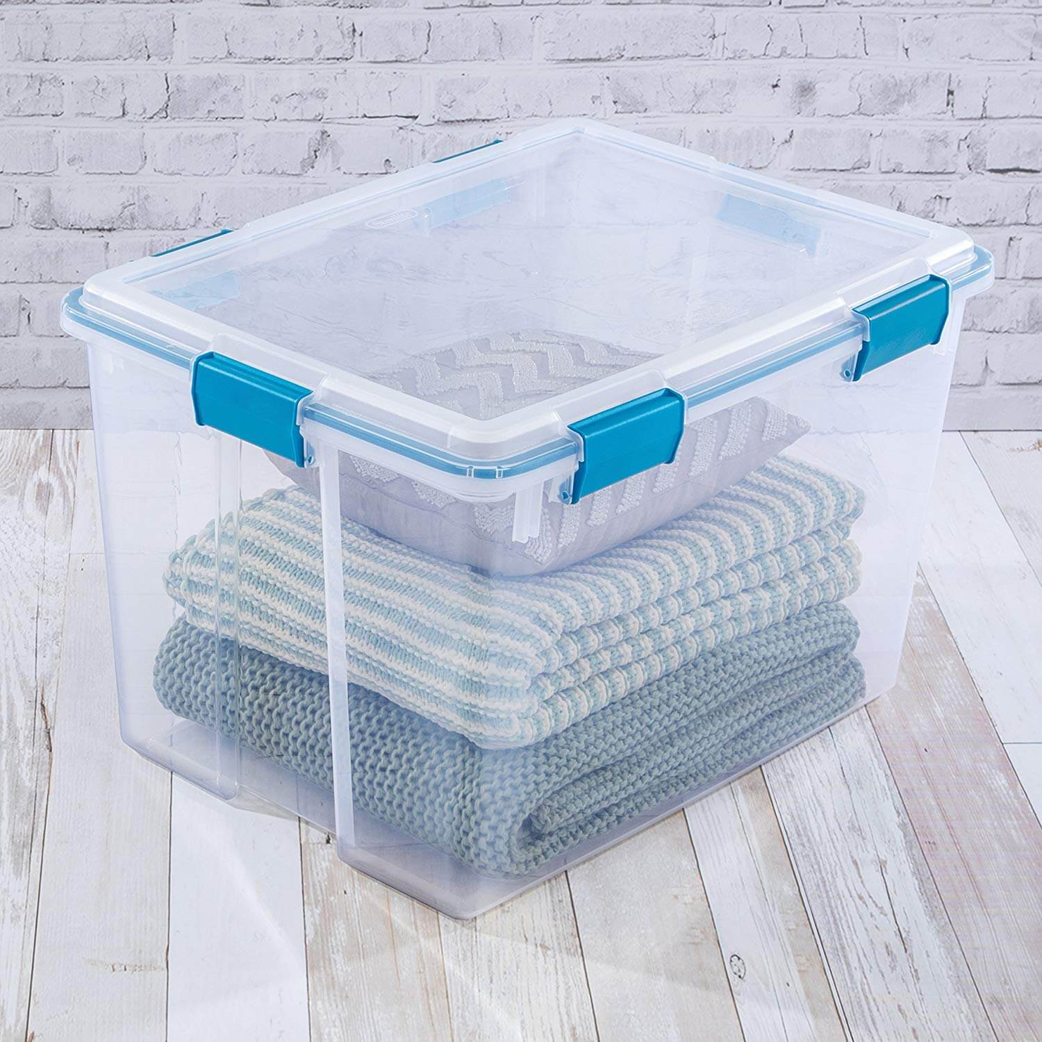 plastic bin with sweaters inside