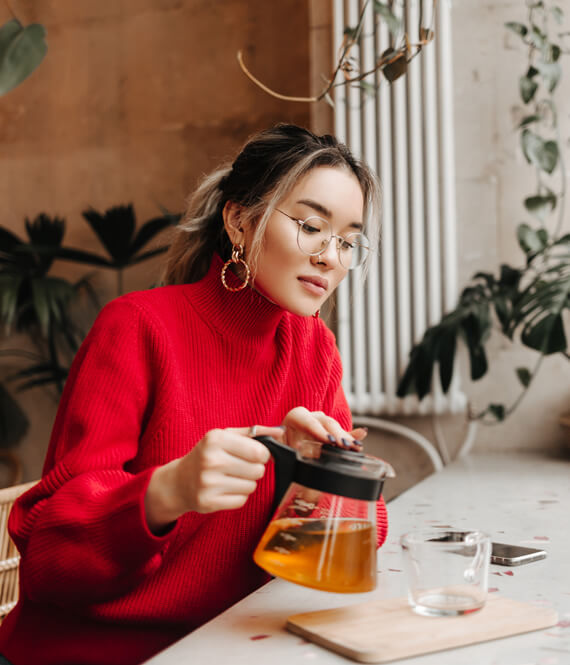 woman pouring morning tea to soothe morning anxiety
