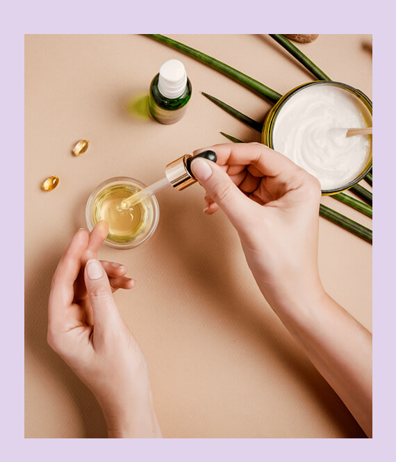 woman using body oil for purple stretch marks