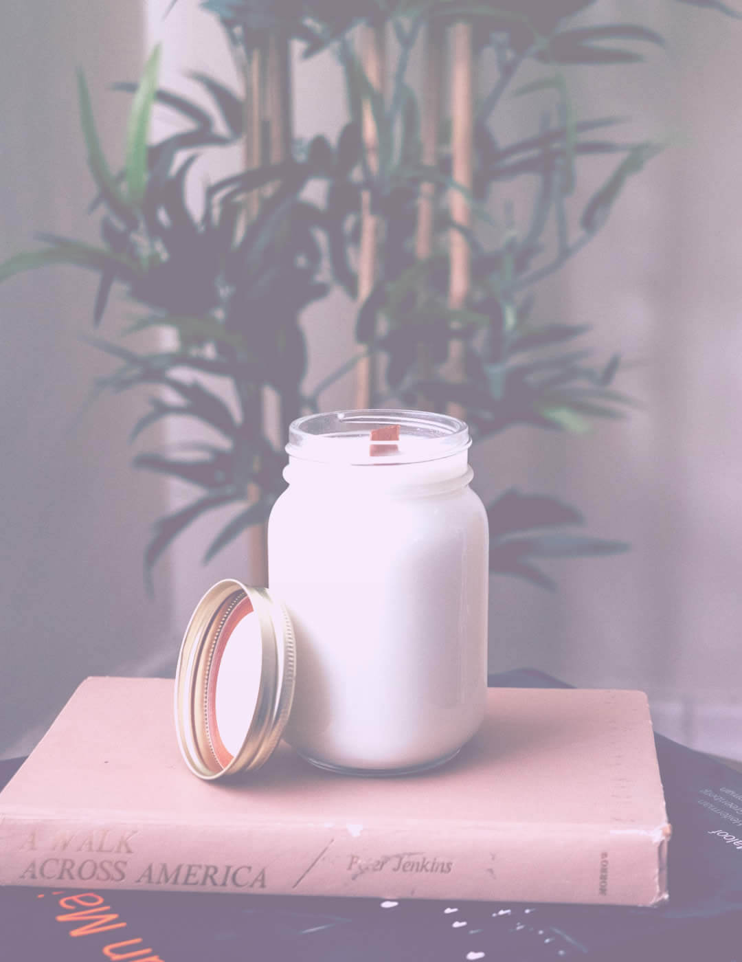 White candle on the book as a before-bed idea on how to sleep with anxiety