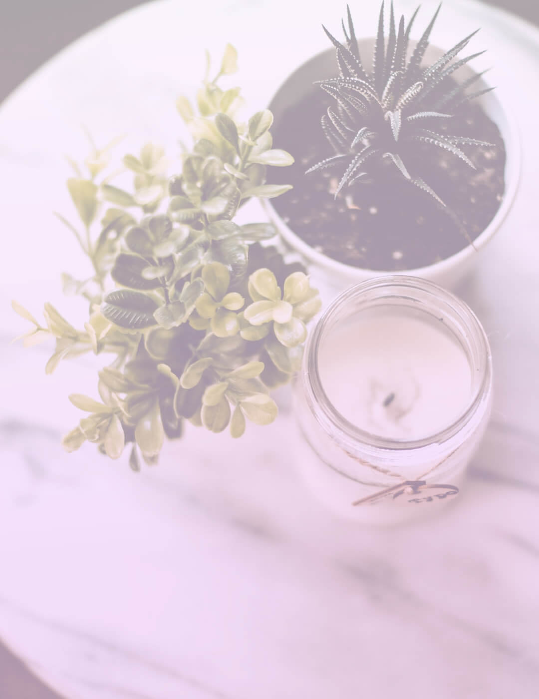 glass candles and plants on a table in a meditation room
