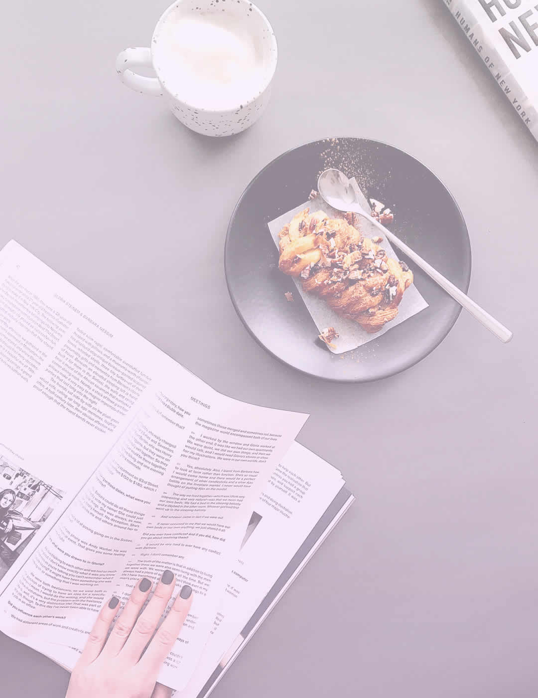 woman eating tasty breakfast and reading newspaper