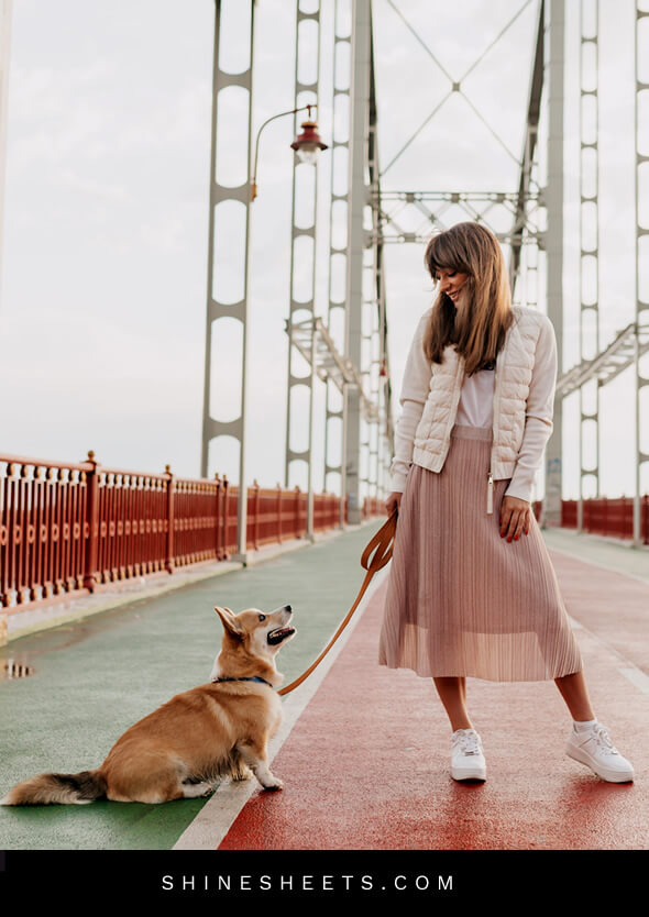 stylish happy woman walking her dog as an example of how to enjoy life
