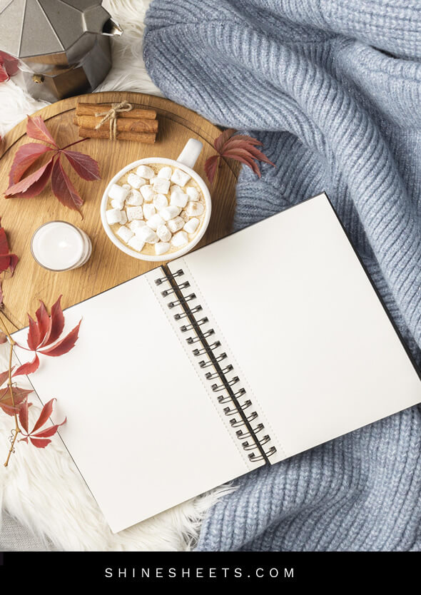 journal for therapy, cup of cocoa and fall leaves on the bed