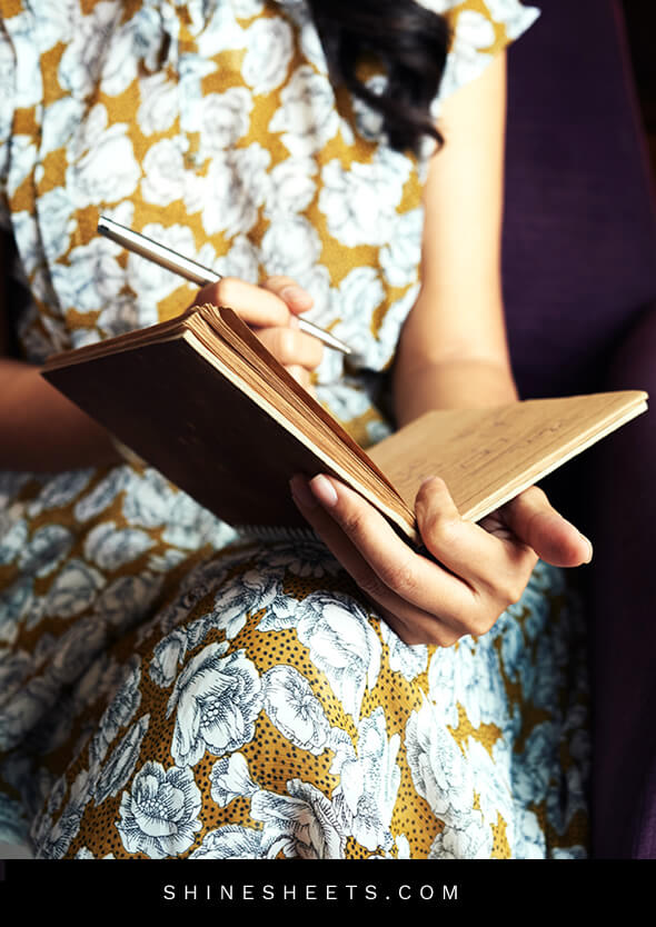 unrecognizable woman writing in a journal for therapy