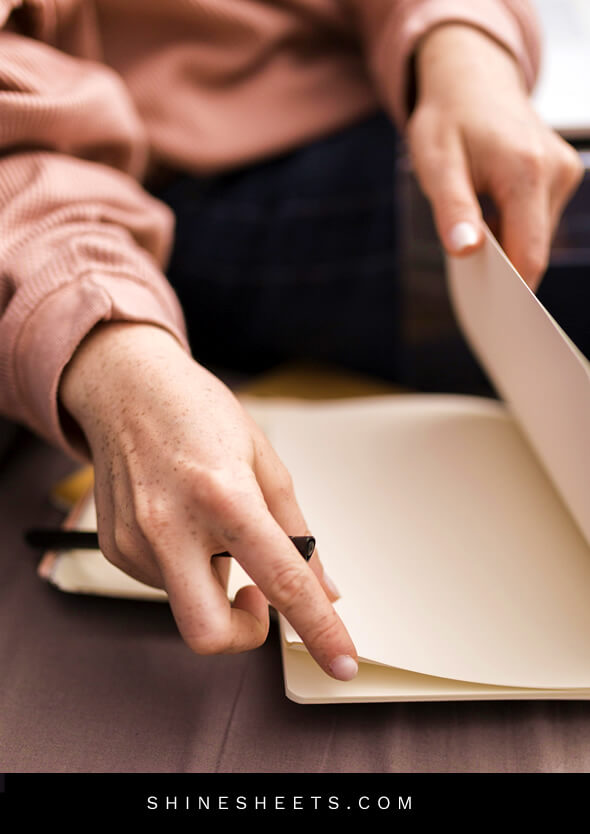 woman opening up a journal for therapy