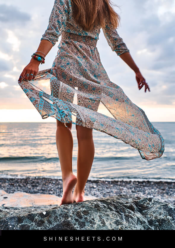 woman walking on the beach in a beautiful flowing dress