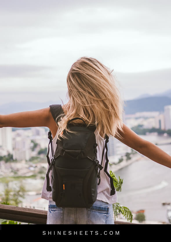 happy woman on top of the city traveling to let go of the past