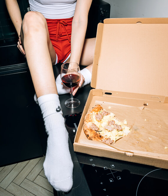 woman after binge eating overeating episode with pizza