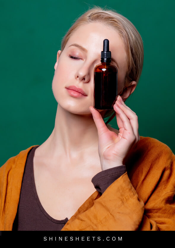 woman with closed eyes and rosehip oil for face