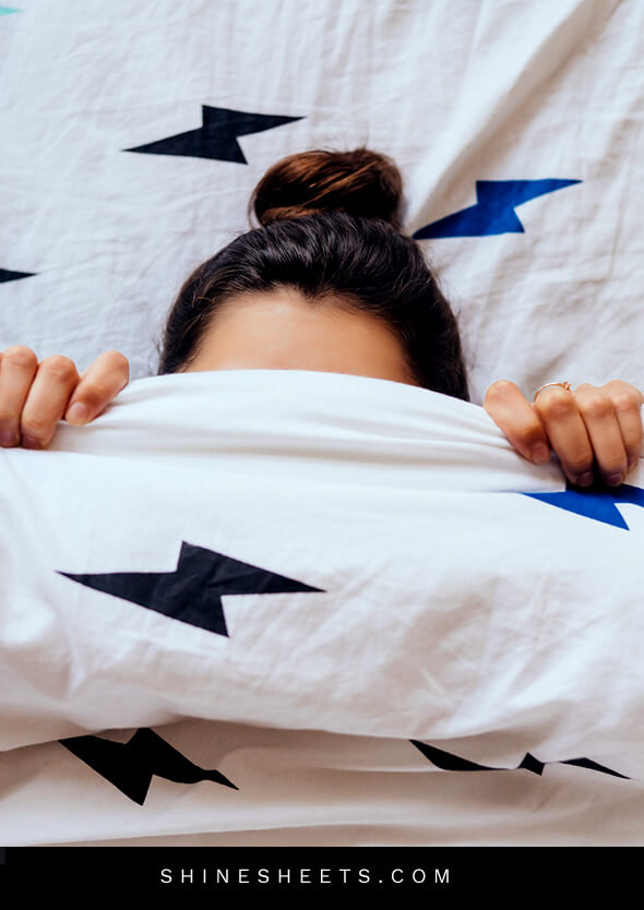 shy girl with fear of confrontation hiding under covers
