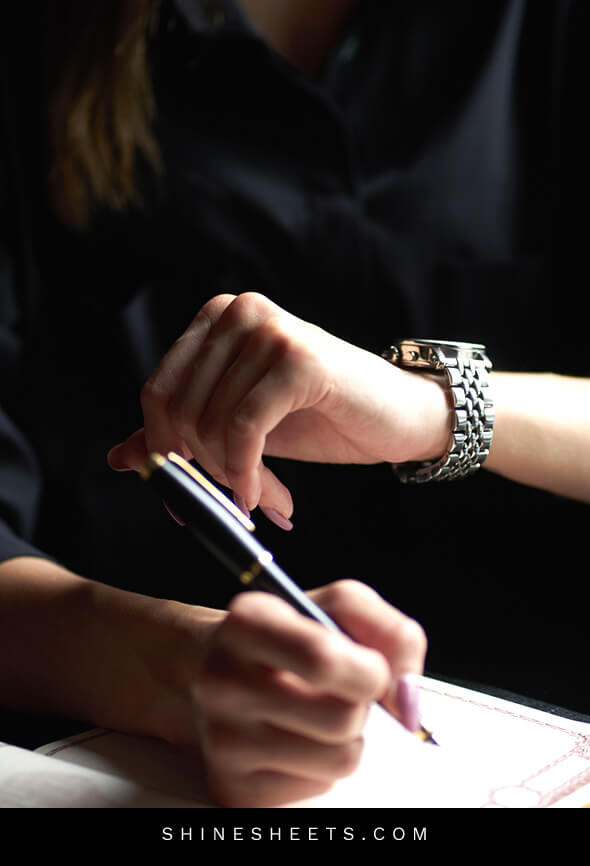 woman looking at her watch as part of her punctuality lady rules