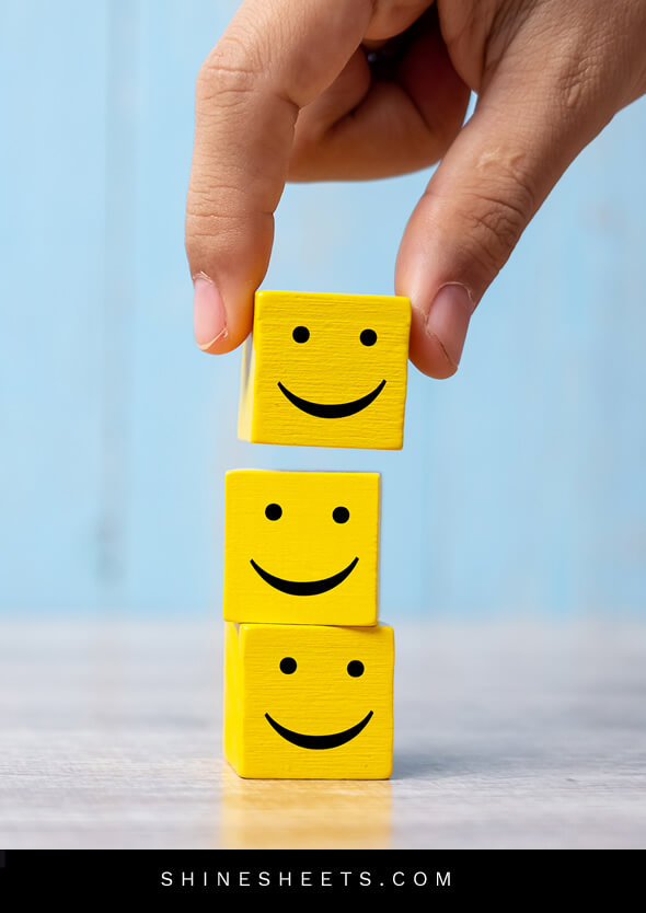 person building smiling blocks as a concept of living happier by choice