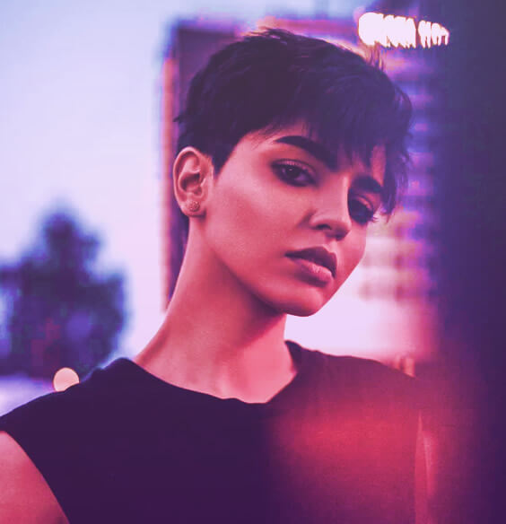 Confident girl with short hair standing in the sunset, learning how to build discipline