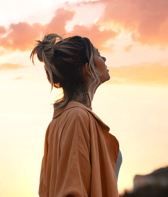 woman overthinking in the sunset