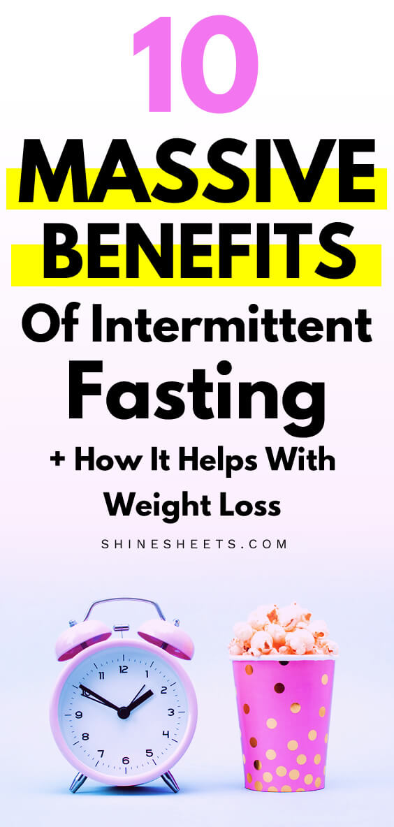Pink clock and a cup of popcorn as an illustration of intermittent fasting