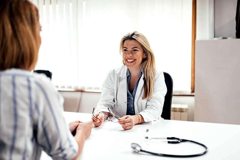 Woman sits in a doctors office to talk about her health anxiety