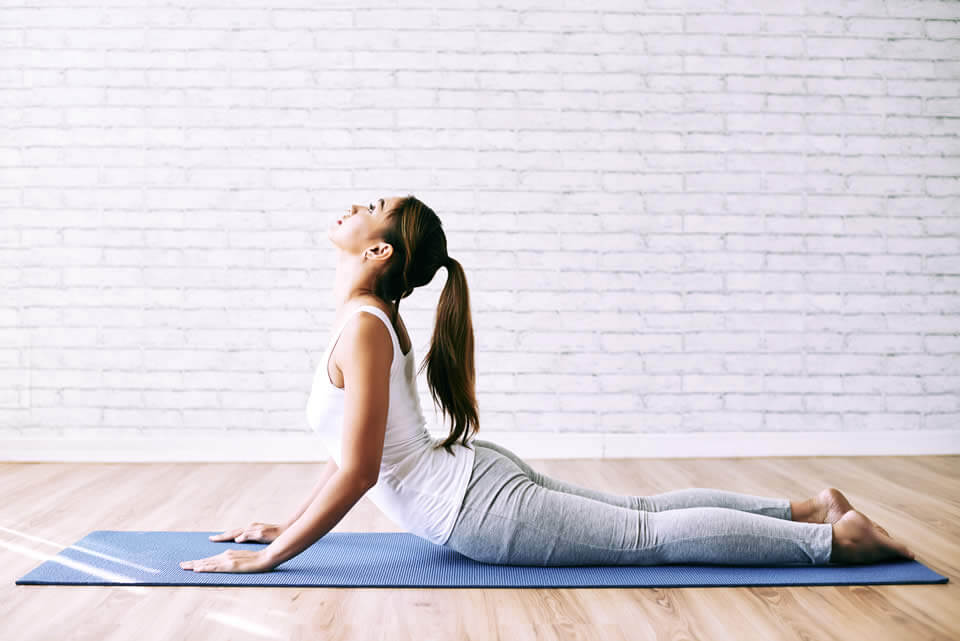 Young beautiful woman doing yoga in the morning
