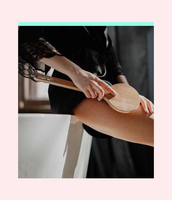 woman dry brushing her body to be healthier