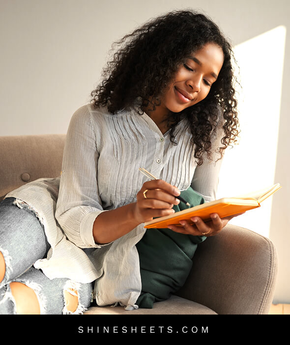 beautiful black woman journaling to stop expecting the worst