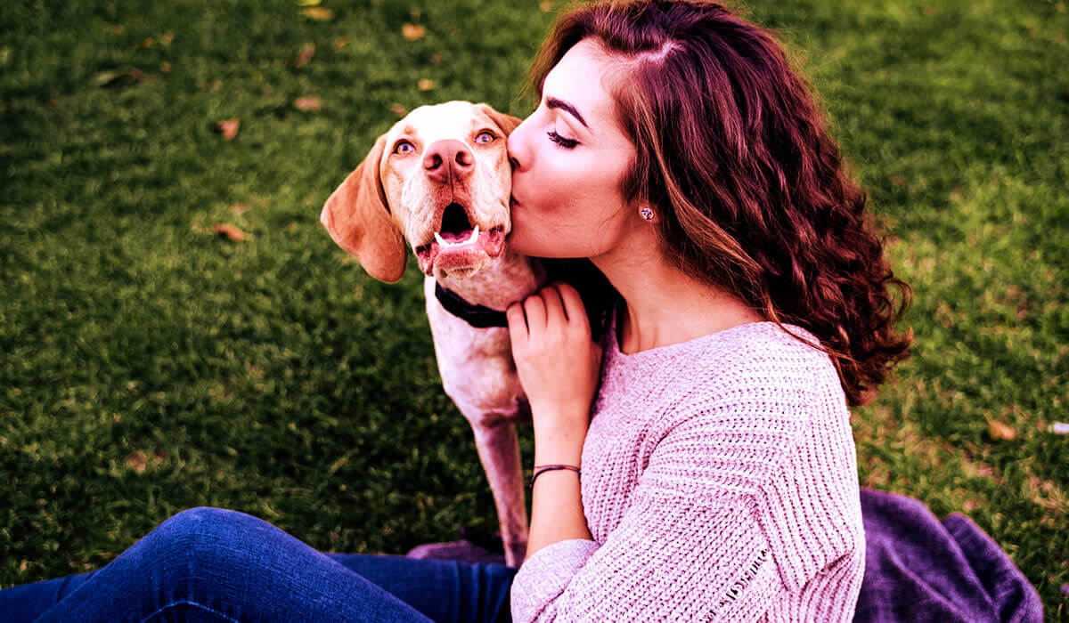 A young woman shows how to have fun by playing with pets