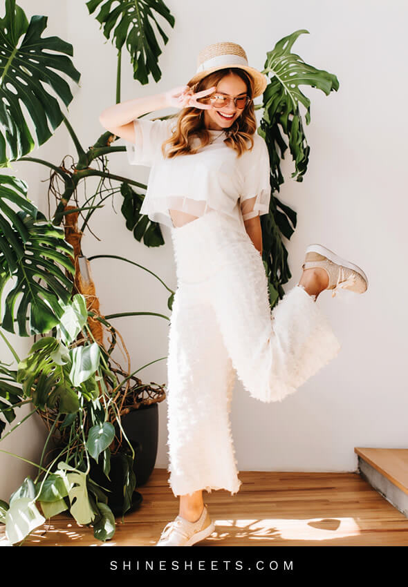 stylish young woman with a hat shows how to have fun alone
