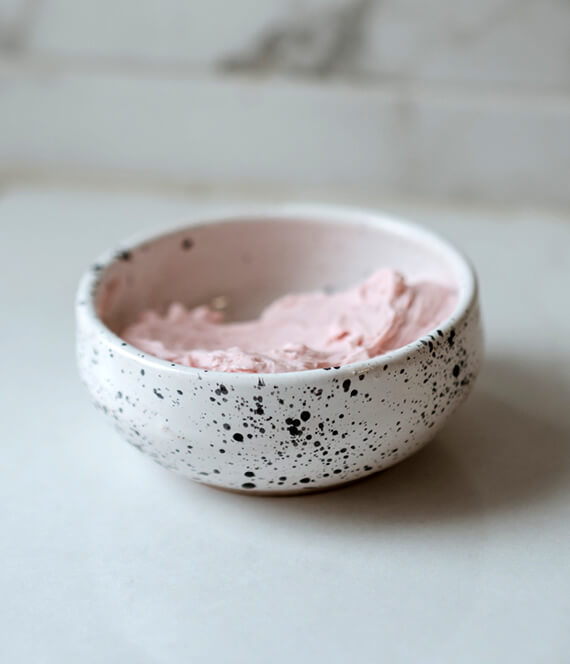 a bowl of pink clay mask