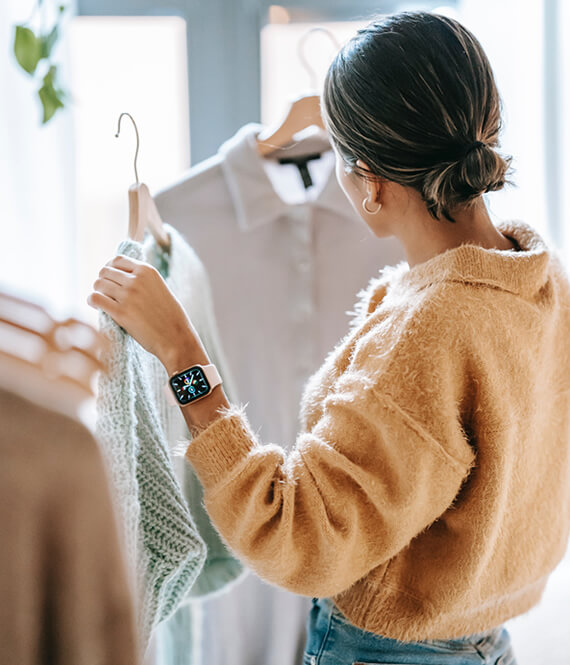 indecisive woman trying to pick clothes in the morning