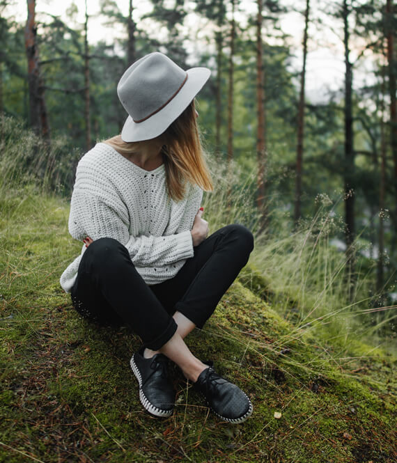 introverted girl sitting in the forest meditating