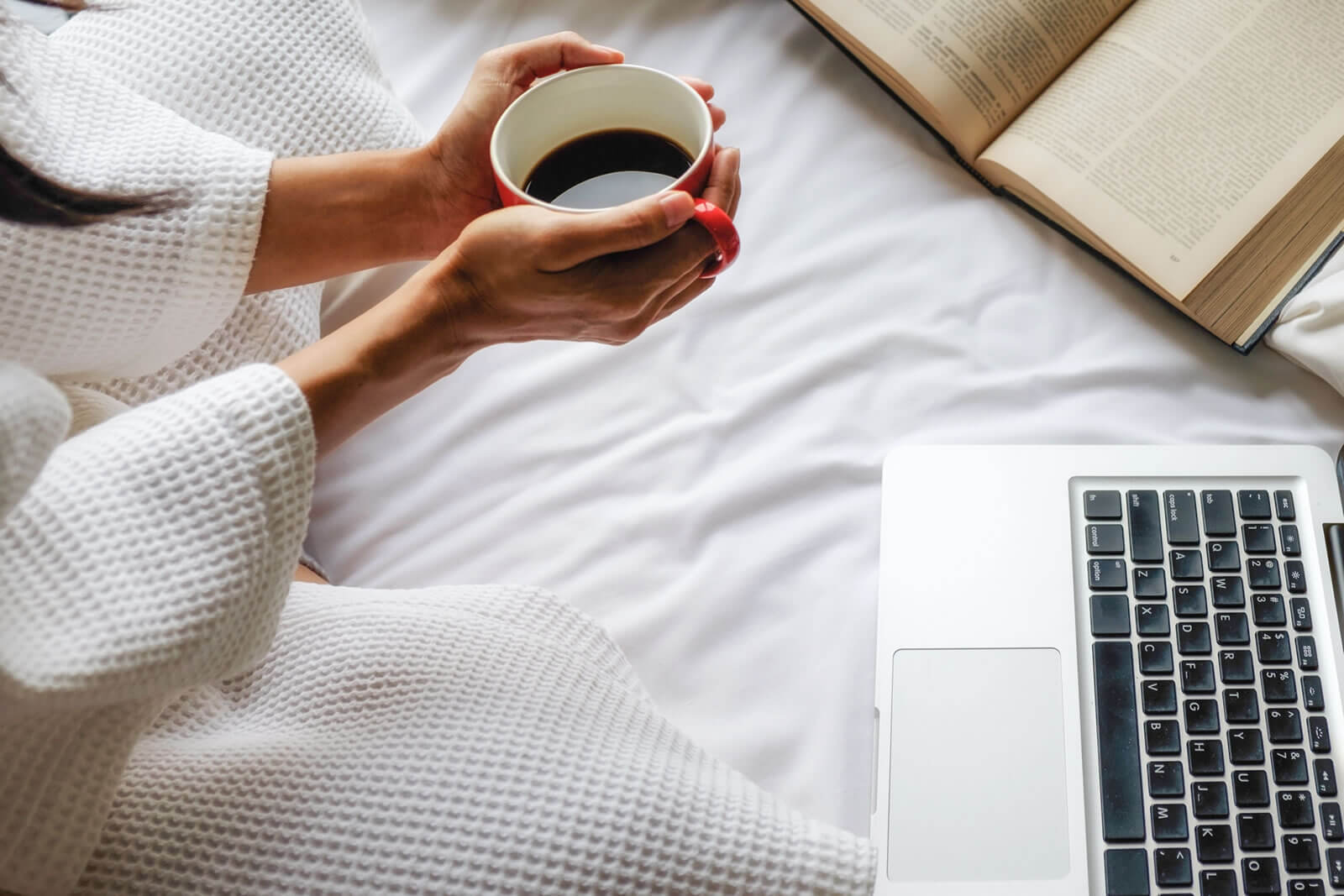 woman watching videos on her laptop and coffee as one of motivational activities