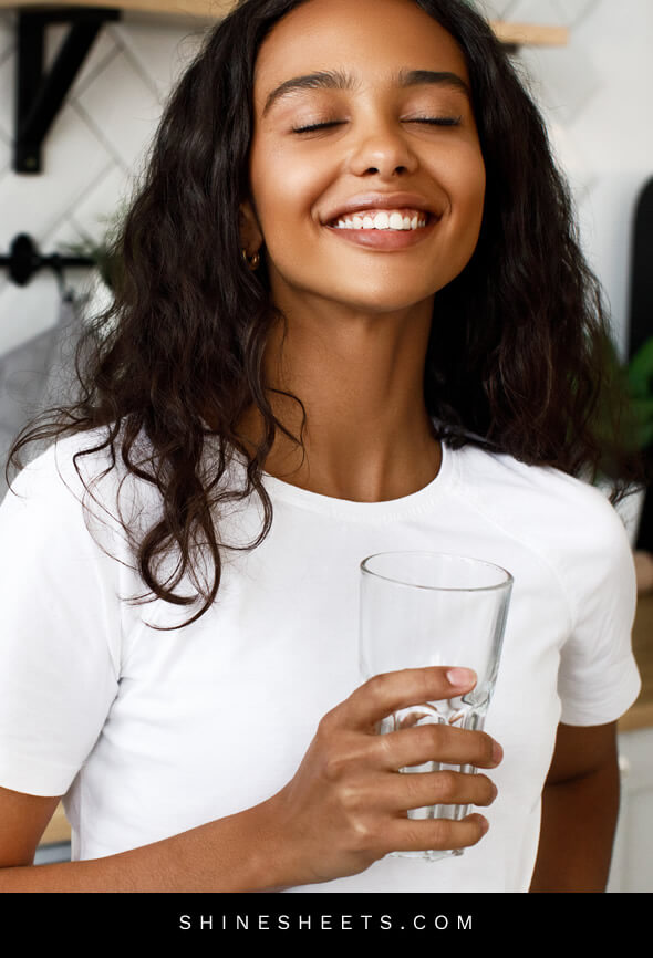 pretty woman with slim face drinks water
