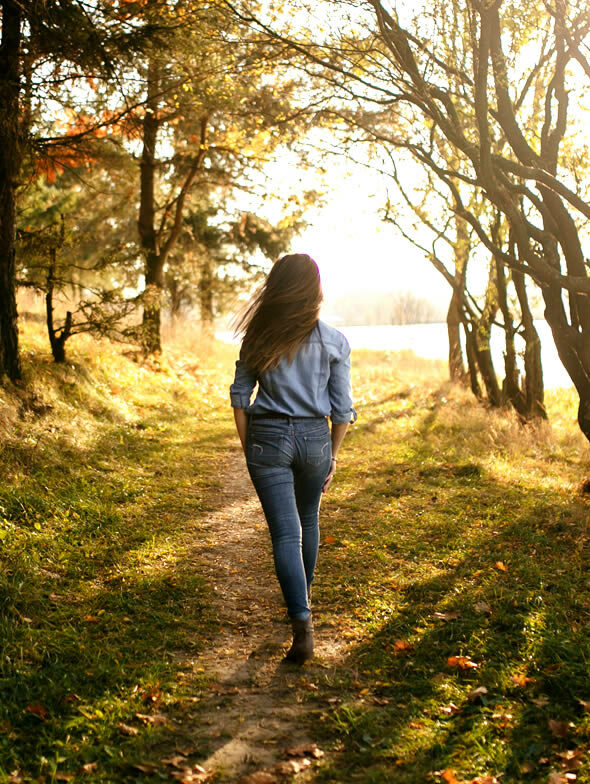 woman taking a walk in nature to find inner happiness