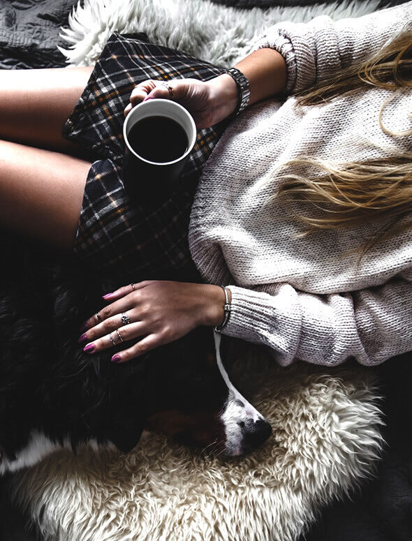 woman with her dog drinking coffee as an illustration of inner happiness