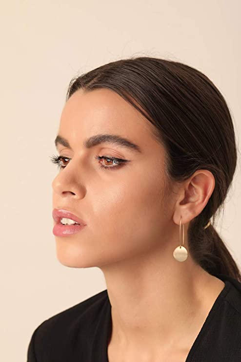 Beautiful woman shows how to be pretty with statement earrings