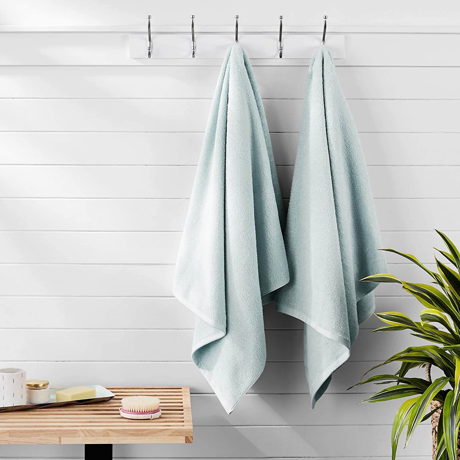 Neat and clean mint towels hanging in the bathroom