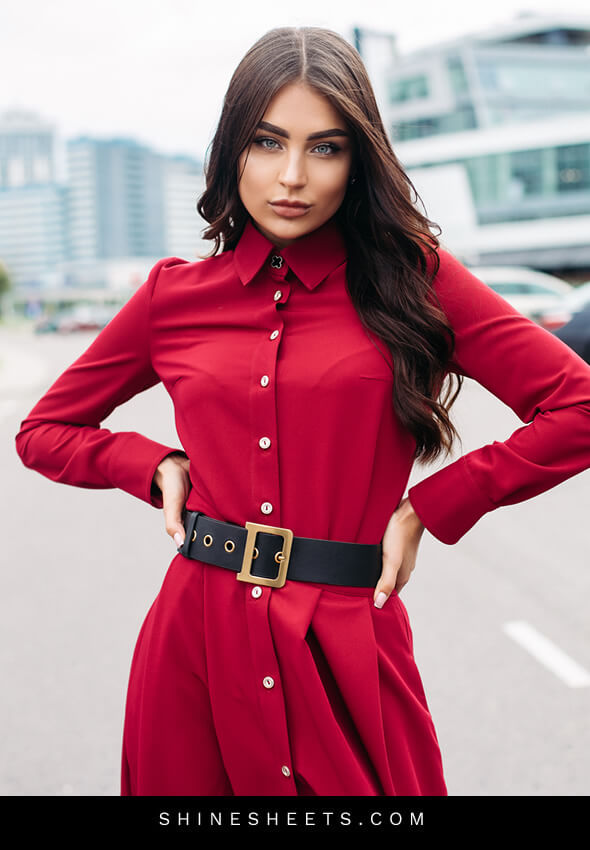 confident woman in a red dress as an illustration of how to be a lady