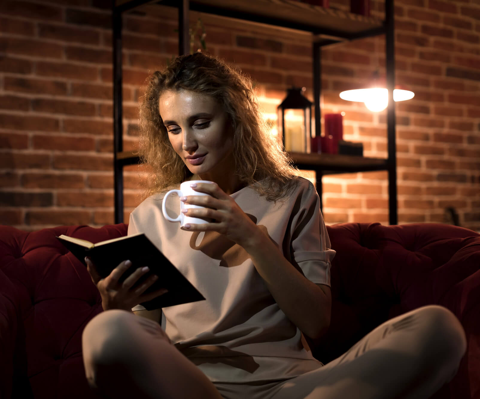 Woman reading on her night routine and sipping tea