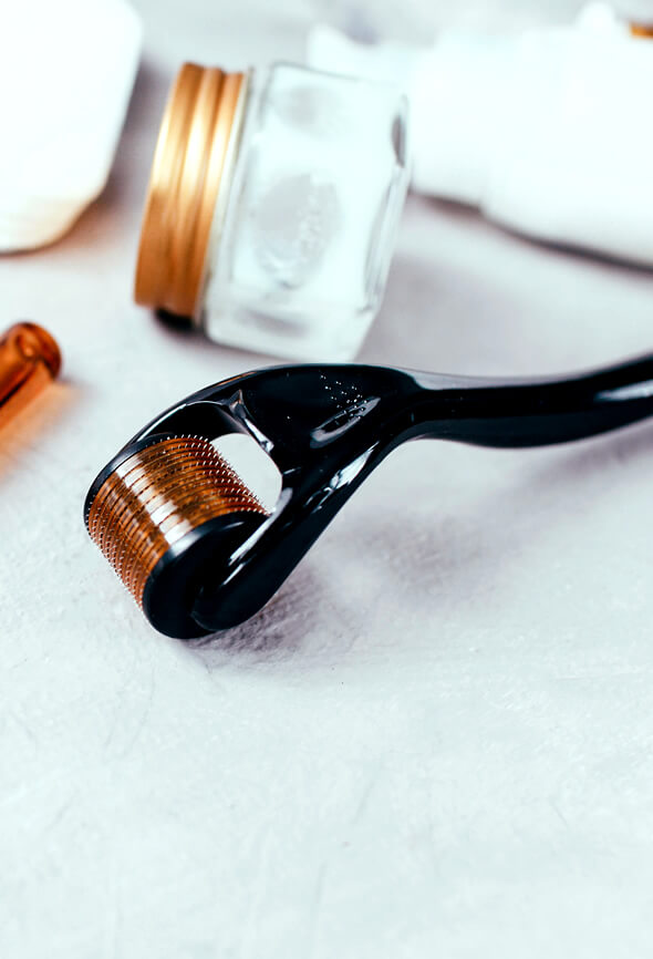 derma roller and cream bottle on the table