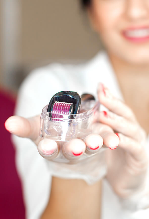 skincare esthetician holding a derma roller