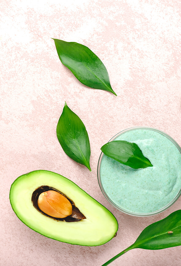 homemade avocado face pack and half of avocado on the table