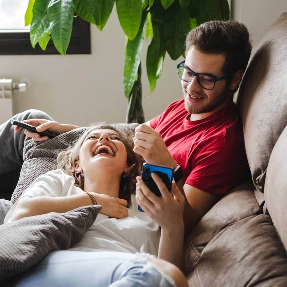 Cute couple on bed showing how to make someone love you by chatting
