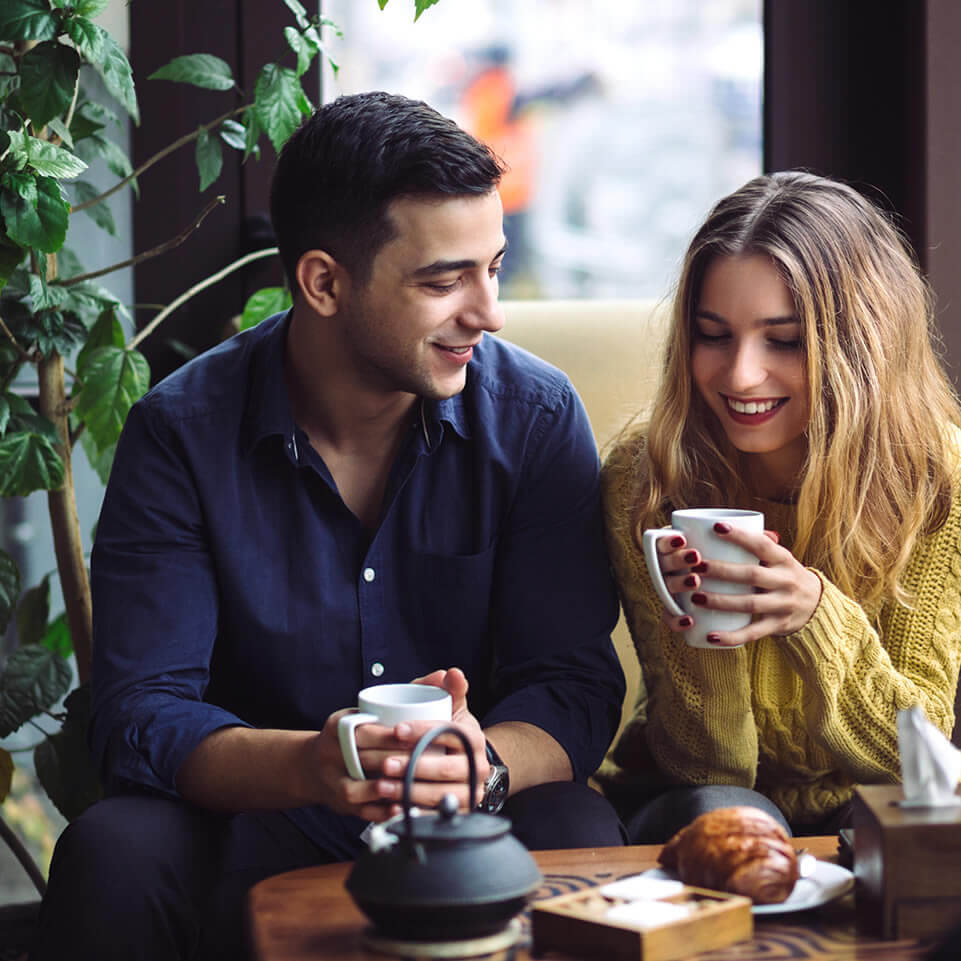 Couple drinking tea at the coffee shop and bonding