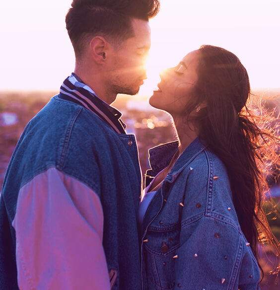 couple in the evening with cute jackets about to kiss