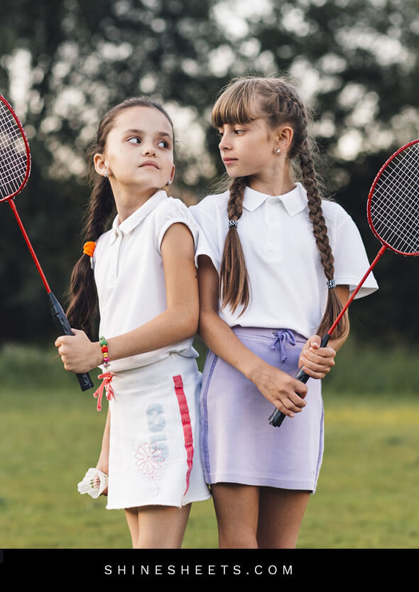 two angry little sister girls playing raquette