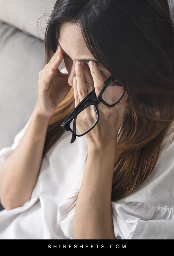 woman looks very tired because she is dealing with work overload