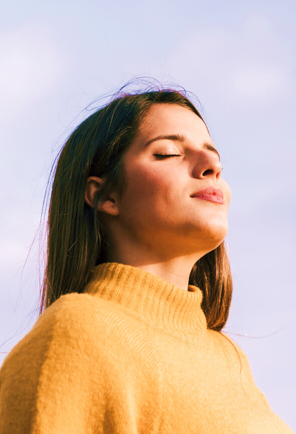 woman taking deep breaths to feel better