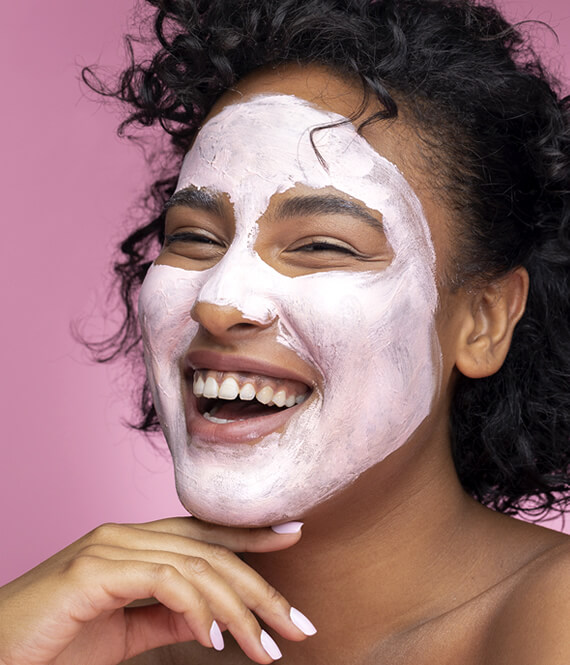 woman using a face pack on her skin