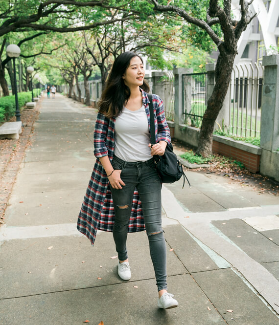 healthy-looking asian korean woman walking for her walking challenge