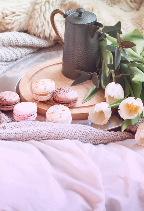 peaceful life illustration with cocoa and macaroons on bed